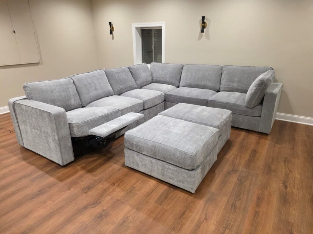 Finished grey Lovesac Sactional with the power recliner footrest extended