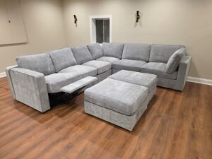 Finished grey Lovesac Sactional with the power recliner footrest extended
